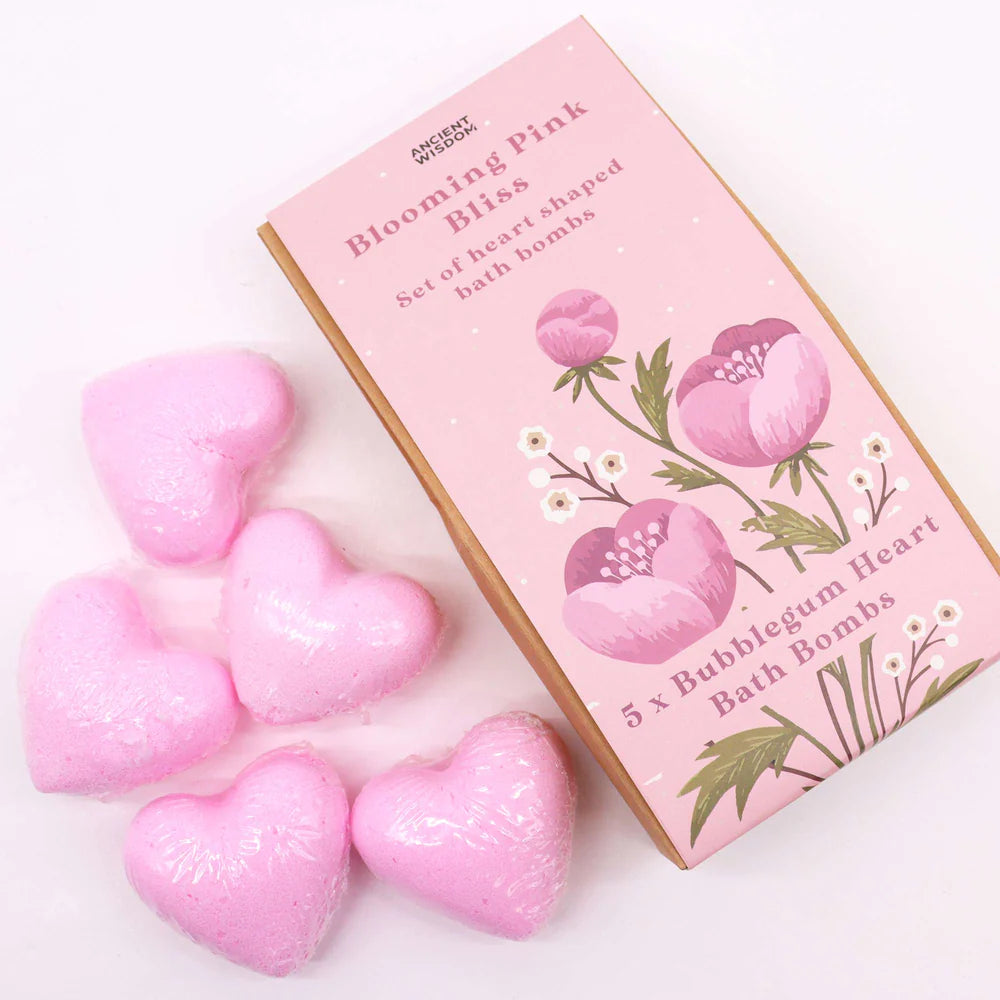 Pink heart-shaped bubblegum bath bombs arranged beside Lumaysa Pink Bliss floral gift box for a playful self-care and gifting concept