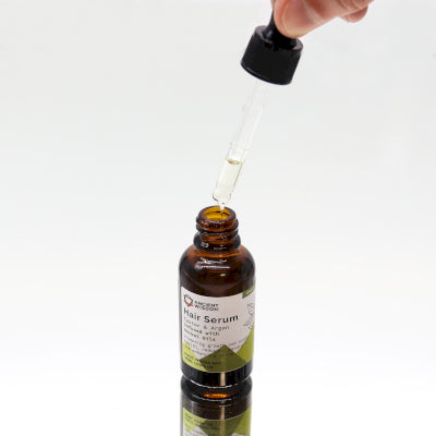 Applying Lumaysa Herbal Harmony Elixir hair serum using dropper, lightweight botanical oil for roots and scalp care

