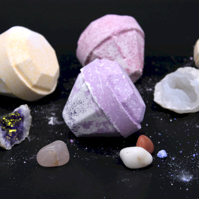 Lumaysa gemstone bath bombs styled with natural crystals on dark background, luxury self-care bath ritual with hidden gemstones and bold fragrance