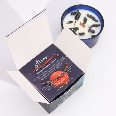 Lumaysa Aries Zodiac Harmony candle gift box opened showing soy wax candle with hidden crystals and Red Jasper gemstone bracelet