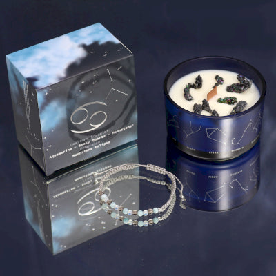 Lumaysa Zodiac Harmony Cancer Crystal Soy Candle with Moonstone bracelet and constellation gift box on a reflective surface