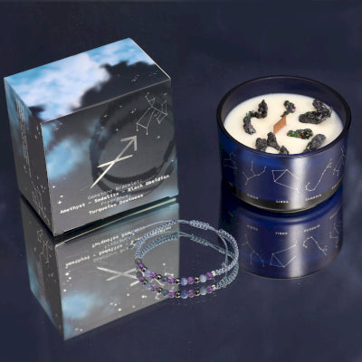 Lumaysa Sagittarius Fire & Freedom Zodiac Candle with gemstone bracelet, soy wax candle in constellation glass jar with gift box on a reflective surface 